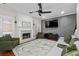 Inviting living room featuring a fireplace, decorative wall accents, comfortable seating, and a ceiling fan at 2971 Montview Sw Dr, Marietta, GA 30060