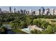 An aerial view of a city park with a swimming pool and city skyline in the background at 1101 Juniper Ne St # 721, Atlanta, GA 30309