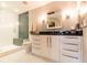 Updated bathroom featuring a glass-enclosed shower, modern vanity with a black countertop, sleek fixtures, and a decorative mirror at 1101 Juniper Ne St # 721, Atlanta, GA 30309