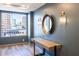 Hallway with attractive wall decor, table and light wood-look floors plus city view from a large window at 1101 Juniper Ne St # 721, Atlanta, GA 30309