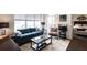 Bright and airy living room featuring a comfortable blue sofa, modern coffee table, and large windows with city views at 1101 Juniper Ne St # 721, Atlanta, GA 30309