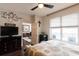 Spacious bedroom with ceiling fan, a view into the adjacent room and access to the balcony at 1101 Juniper Ne St # 721, Atlanta, GA 30309