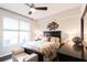Comfortable main bedroom featuring a large window, ceiling fan, and stylish bed with a patterned comforter and decorative pillows at 1101 Juniper Ne St # 721, Atlanta, GA 30309