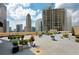 Urban rooftop deck with seating, planters, and city views for entertaining and relaxing at 1101 Juniper Ne St # 721, Atlanta, GA 30309
