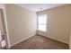 Bedroom with beige colored walls, carpet and a window lets in plenty of light at 1830 Bayrose Cir # 30B, East Point, GA 30344