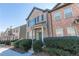 Charming two-story brick townhome features well-maintained landscaping along a sidewalk at 1830 Bayrose Cir # 30B, East Point, GA 30344