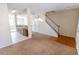 View of the living room leading to the kitchen and staircase with wooden rails at 1830 Bayrose Cir # 30B, East Point, GA 30344