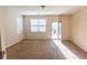 Open-concept living room featuring natural light from the windows and access to an outdoor patio at 1830 Bayrose Cir # 30B, East Point, GA 30344