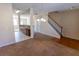 Open-concept living room showcasing the staircase and view into the kitchen at 1830 Bayrose Cir # 30B, East Point, GA 30344