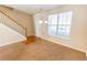 Inviting living room featuring a staircase, large window, and neutral carpet at 1830 Bayrose Cir # 30B, East Point, GA 30344