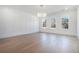 Elegant dining room featuring hardwood floors, wainscoting details, and a modern chandelier at 3825 Hall Rd, Dacula, GA 30019