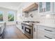Gourmet kitchen boasts stainless steel appliances, white cabinetry, and a stunning tile backsplash at 3825 Hall Rd, Dacula, GA 30019