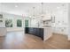 Spacious kitchen with large island, quartz countertops, stylish lighting, and stainless steel appliances at 3825 Hall Rd, Dacula, GA 30019