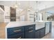 Close-up of the kitchen island featuring a farmhouse sink, quartz countertops, and modern hardware at 3825 Hall Rd, Dacula, GA 30019