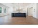 Gourmet kitchen featuring a large island, white cabinets, modern appliances, and hardwood floors at 3825 Hall Rd, Dacula, GA 30019
