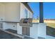 Covered outdoor kitchen features a stainless steel grill and ample counter space, perfect for entertaining at 3825 Hall Rd, Dacula, GA 30019