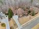 An aerial view shows this house's placement in a wooded cul-de-sac with an in-ground pool at 829 Waterford Estates Mnr, Canton, GA 30115