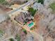 An aerial view shows this large lot with a pool, neighboring houses and a wooded backdrop at 829 Waterford Estates Mnr, Canton, GA 30115