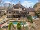 A large backyard showcases an in-ground pool, decks, outdoor kitchen and beautiful landscaping at 829 Waterford Estates Mnr, Canton, GA 30115