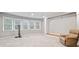 Spacious finished basement with plush carpeting, natural light from large windows, and comfortable seating at 829 Waterford Estates Mnr, Canton, GA 30115