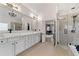 Bright bathroom with double vanity, quartz countertops, and open access to the main bedroom at 829 Waterford Estates Mnr, Canton, GA 30115