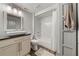 This full bathroom features a white vessel sink on granite counters, a tub and shower, and wood look flooring at 829 Waterford Estates Mnr, Canton, GA 30115