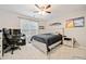 Cozy bedroom with a ceiling fan, a study desk, and natural light from the window at 829 Waterford Estates Mnr, Canton, GA 30115