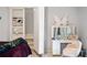 Bedroom featuring a built-in bookcase, a vanity with a lighted mirror, and a hidden staircase at 829 Waterford Estates Mnr, Canton, GA 30115