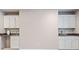 This butler's pantry has white cabinets, granite counters, and a sink, providing extra storage and functionality at 829 Waterford Estates Mnr, Canton, GA 30115