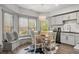 Dining area with a window bench seat, a chandelier, and wood floors, perfect for Gathering meals at 829 Waterford Estates Mnr, Canton, GA 30115