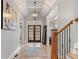 Elegant foyer boasting a tray ceiling, wood floors, and a charming light fixture, creating a grand entrance to the home at 829 Waterford Estates Mnr, Canton, GA 30115