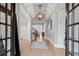 Bright and airy foyer with hardwood floors, complemented by views of the living spaces through stylish glass doors at 829 Waterford Estates Mnr, Canton, GA 30115