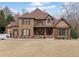 Charming two-story house with a stone facade, covered porch, and well-maintained landscaping at 829 Waterford Estates Mnr, Canton, GA 30115