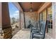 Inviting front porch featuring a stone fireplace and comfortable rocking chairs, perfect for relaxing and enjoying the outdoors at 829 Waterford Estates Mnr, Canton, GA 30115