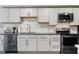 Modern kitchen featuring stainless steel appliances, gray cabinets, and a mosaic backsplash at 829 Waterford Estates Mnr, Canton, GA 30115