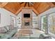 Inviting living room with stone fireplace, wood ceiling, and bright windows at 829 Waterford Estates Mnr, Canton, GA 30115