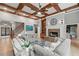 Stylish living room with coffered ceilings, stone fireplace, and hardwood floors, creating a cozy and elegant atmosphere at 829 Waterford Estates Mnr, Canton, GA 30115