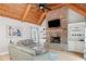 Cozy living room with stone fireplace, wood ceiling, and built in shelving at 829 Waterford Estates Mnr, Canton, GA 30115