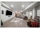 Spacious living room with a large TV, a comfortable sectional sofa, and wood-look floors at 829 Waterford Estates Mnr, Canton, GA 30115