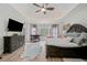 Comfortable main bedroom with a tray ceiling, hardwood floors, and large bed at 829 Waterford Estates Mnr, Canton, GA 30115