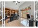 Home office with built-in bookshelves, hardwood floors, and large windows providing plenty of light for a productive workspace at 829 Waterford Estates Mnr, Canton, GA 30115