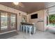 This covered outdoor bar has seating for six, a TV for entertaining, and access to the screened-in porch at 829 Waterford Estates Mnr, Canton, GA 30115
