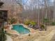A large in-ground pool is surrounded by a patio, landscaping, and seating at 829 Waterford Estates Mnr, Canton, GA 30115