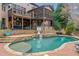A gorgeous in-ground pool features a waterfall feature, a diving platform and a tanning deck at 829 Waterford Estates Mnr, Canton, GA 30115