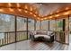 Relax on this screened porch featuring wood floors and views of the outdoors at 829 Waterford Estates Mnr, Canton, GA 30115