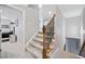 Carpeted staircase with wooden railing, leading to upper levels of the home, showcasing modern design at 829 Waterford Estates Mnr, Canton, GA 30115