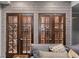 Wine cellar featuring wood and glass doors, with racks for storing wine bottles behind the doors at 829 Waterford Estates Mnr, Canton, GA 30115