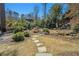 Lush backyard featuring stone pathway, well manicured landscaping, and a tranquil pond at 1239 E Rock Springs Ne Rd, Atlanta, GA 30306