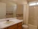 Bathroom vanity and tub/shower combination, with wallpapered walls at 158 Weatherstone Dr, Woodstock, GA 30188
