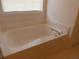 A soaking tub beneath a window is the highlight of this bathroom at 158 Weatherstone Dr, Woodstock, GA 30188